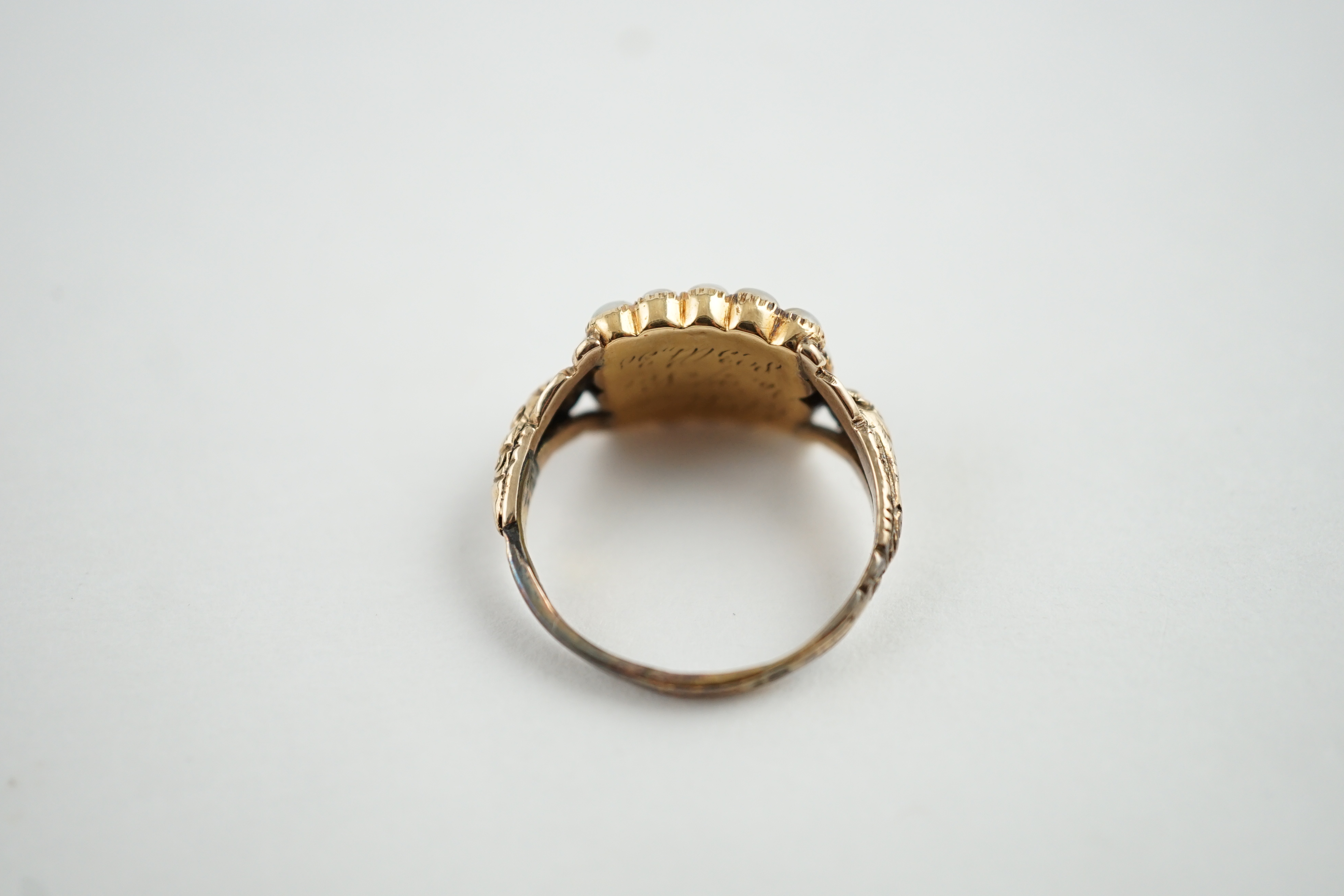 An early Victorian gold, enamel and split pearl mourning ring